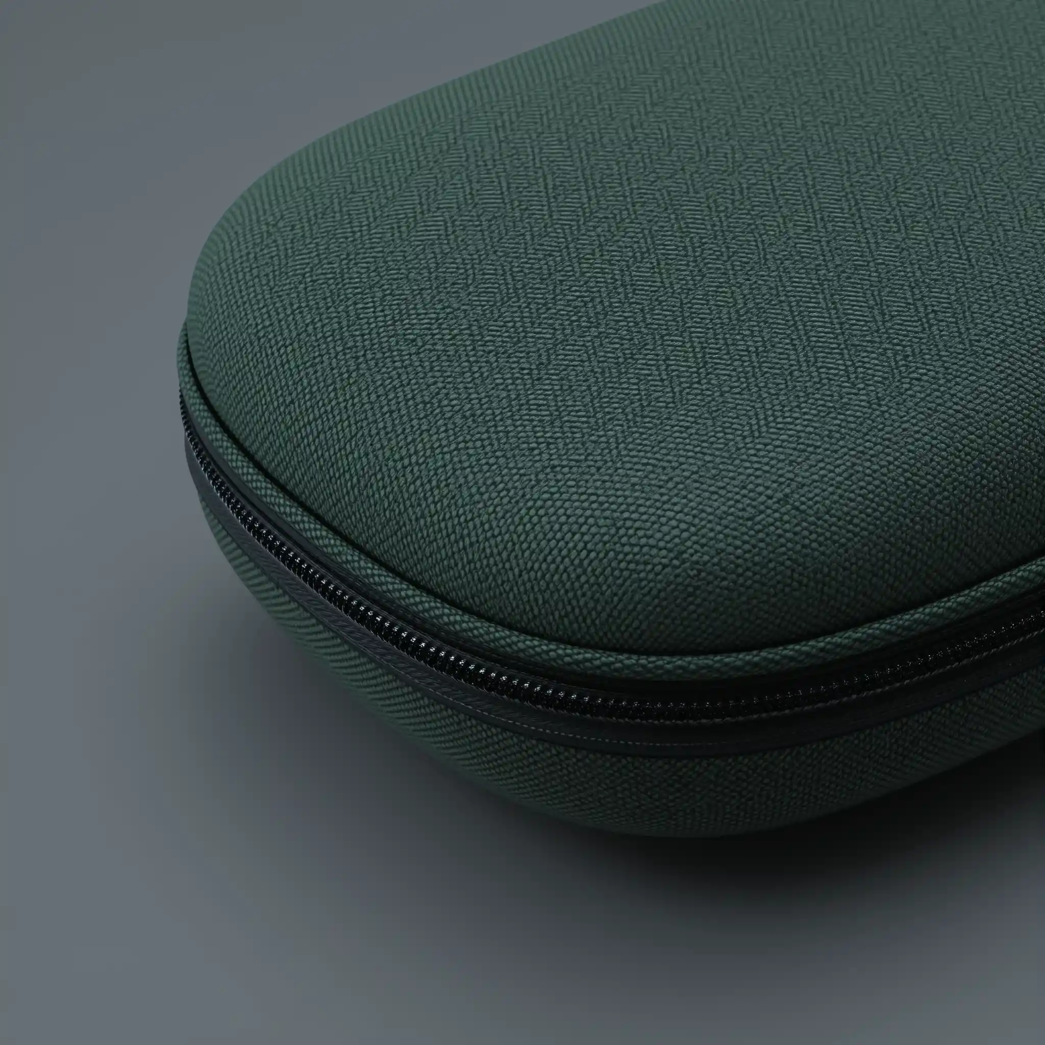 Close up green headphone case on solid gray background
