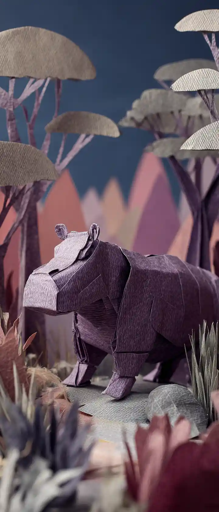 Origami hippopotamus in a textured wildlife diorama scene