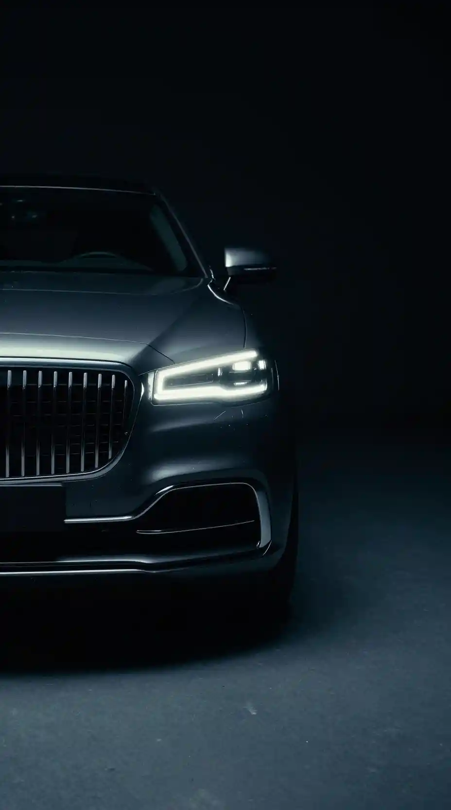 Luxury car emerging from darkness with neon edge lighting