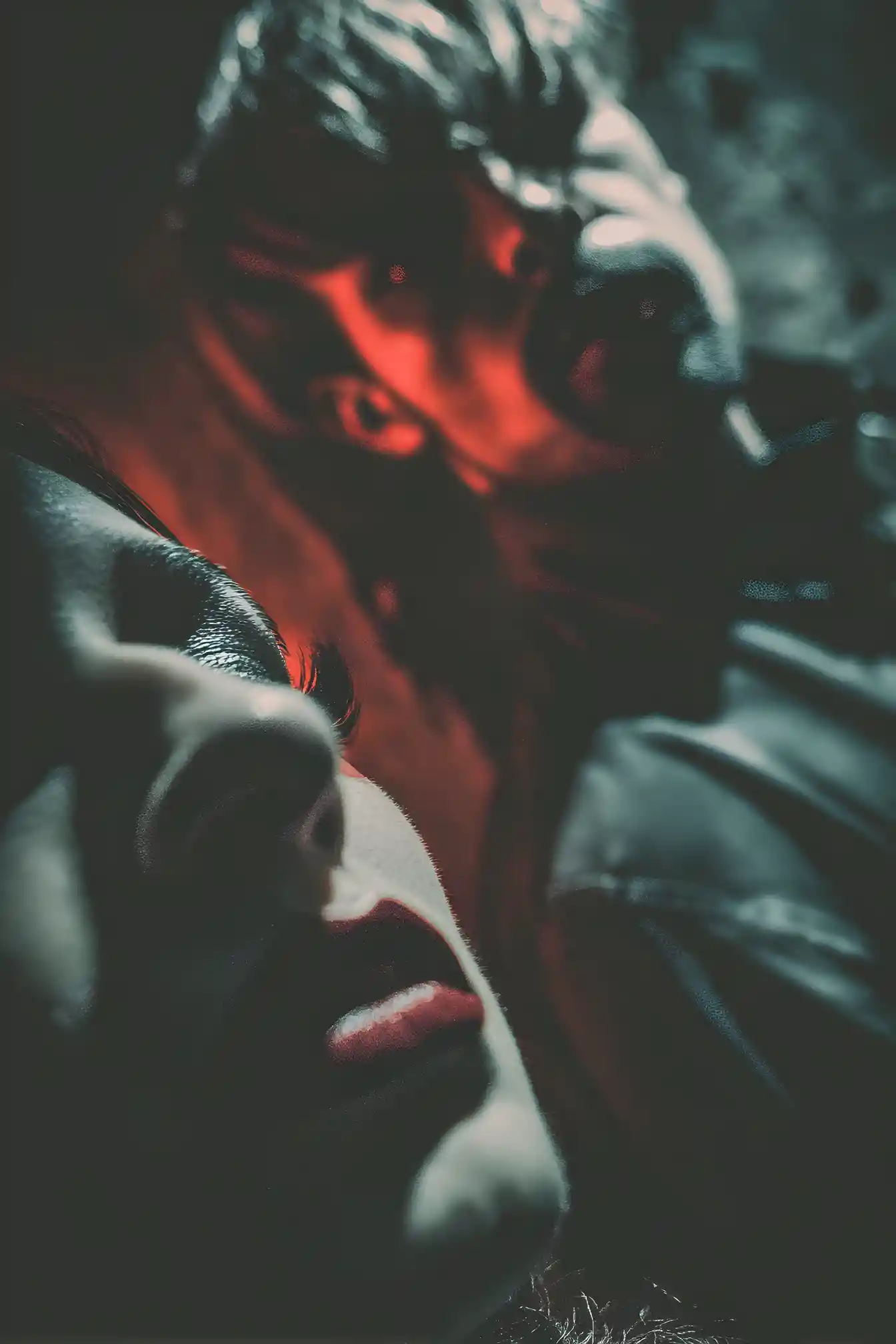 Woman in leather in a dim dungeon basement