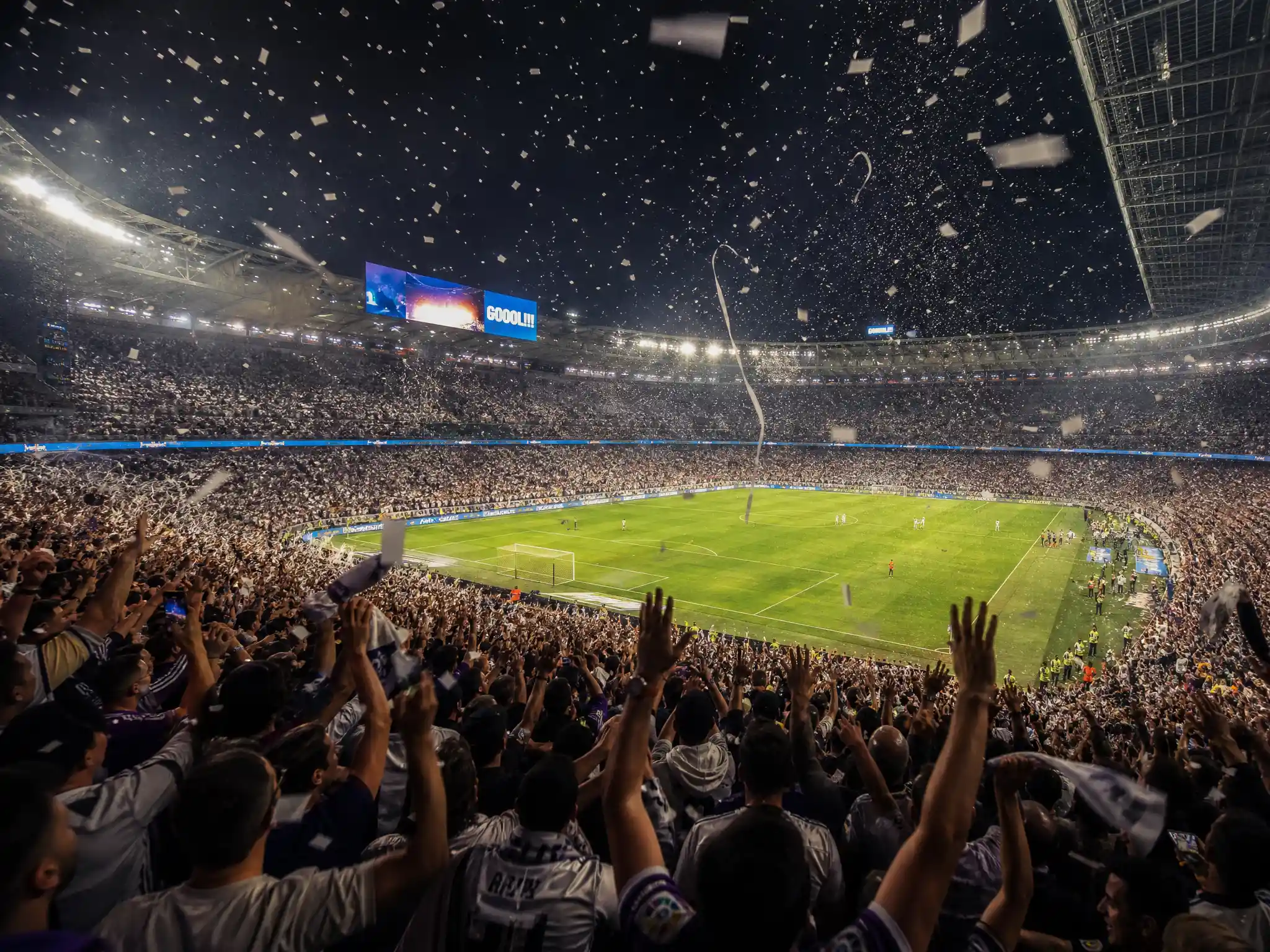Celebrating Football Fans In A Packed Stadium With Confetti
