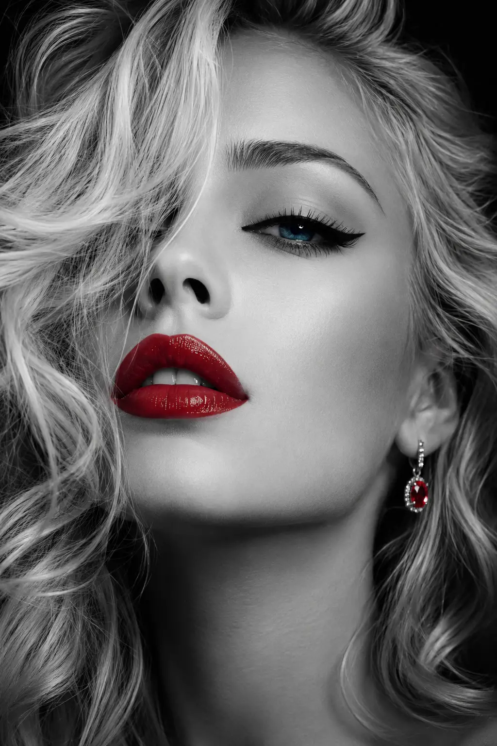 Monochrome close up of woman with blue eyes and red lips