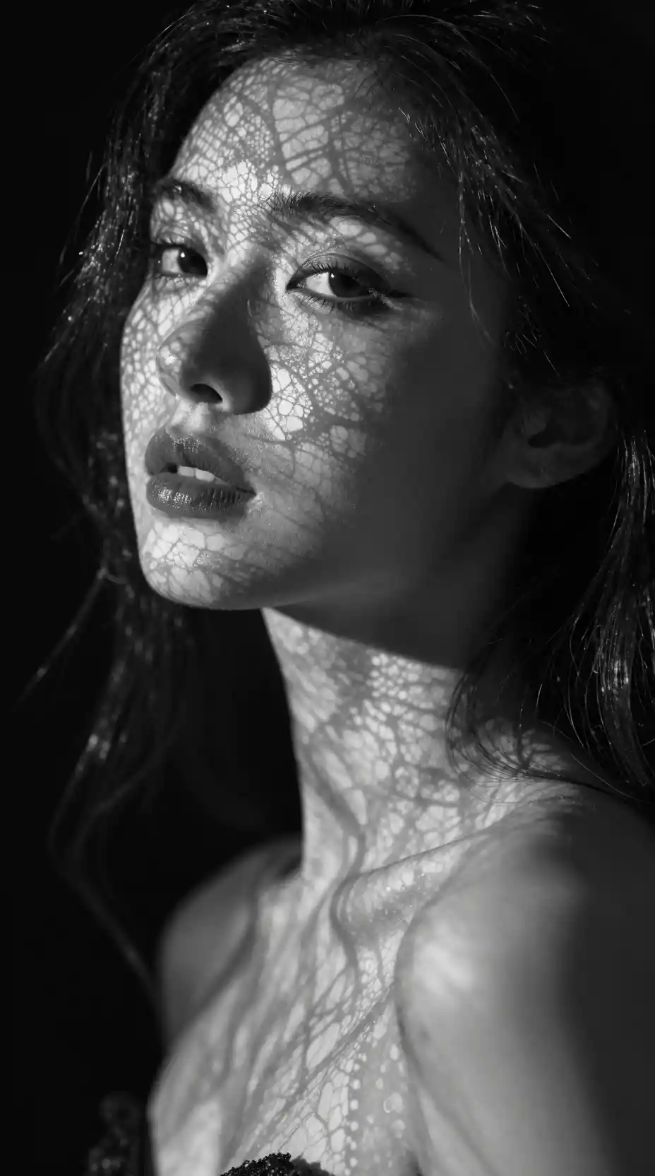 Black and white close up portrait of a mysterious woman