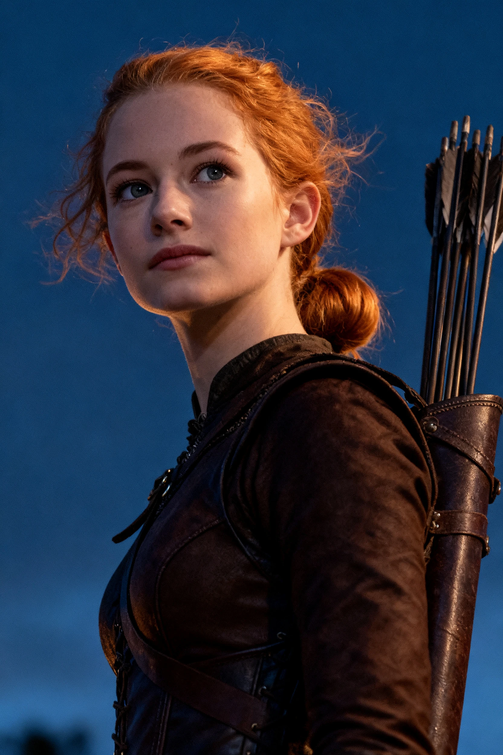 Determined medieval archer girl in cinematic close up portrait