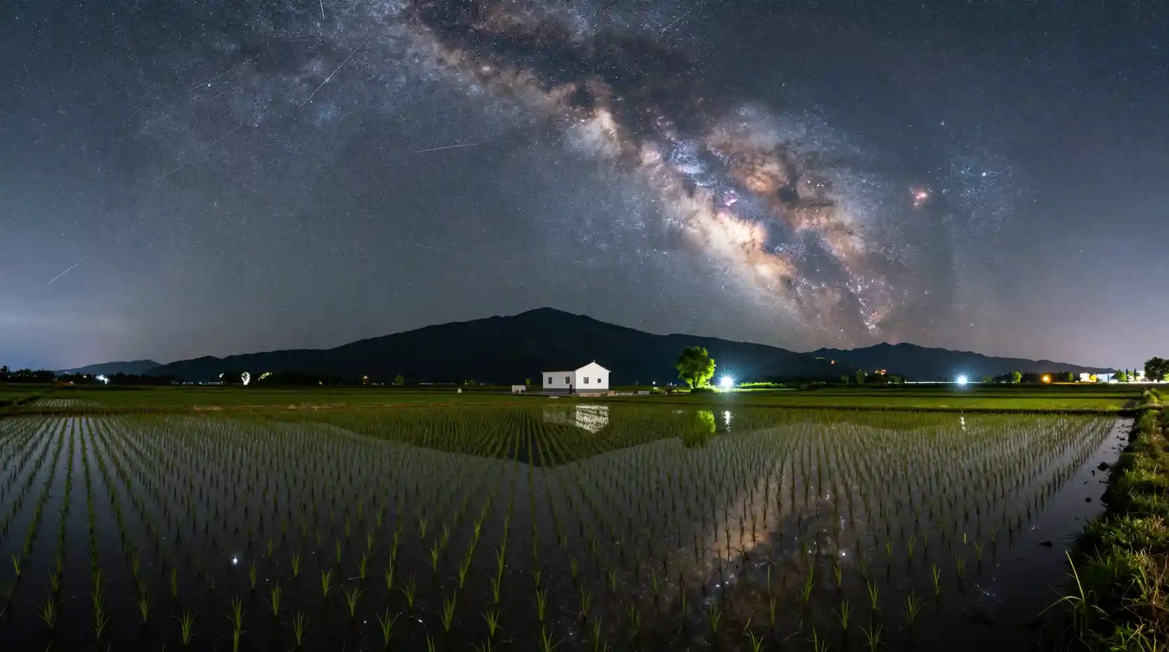 Starry Night Over Flooded Rice Fields And Distant Mountains