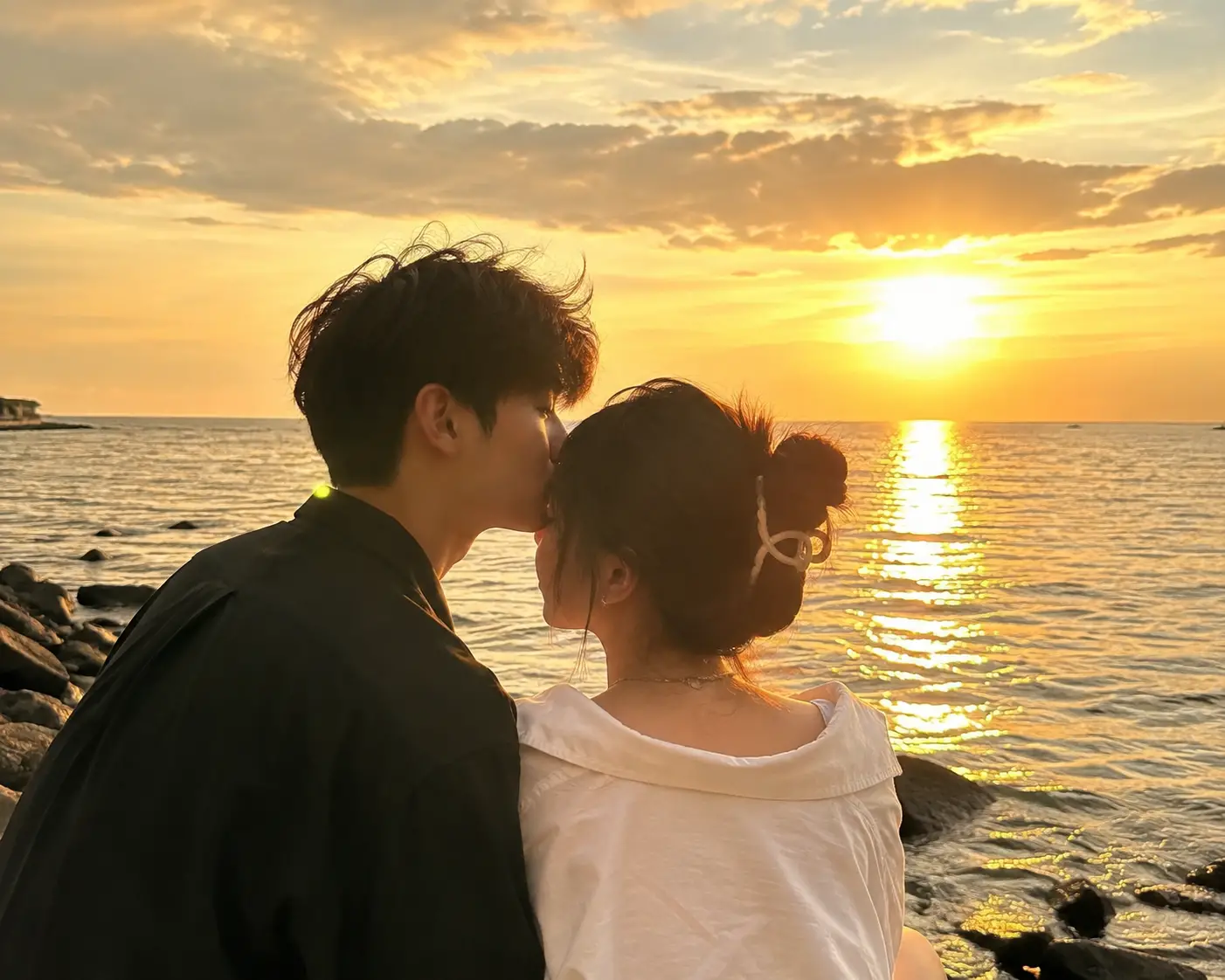 Romantic couple by the sea with warm sunshine glow