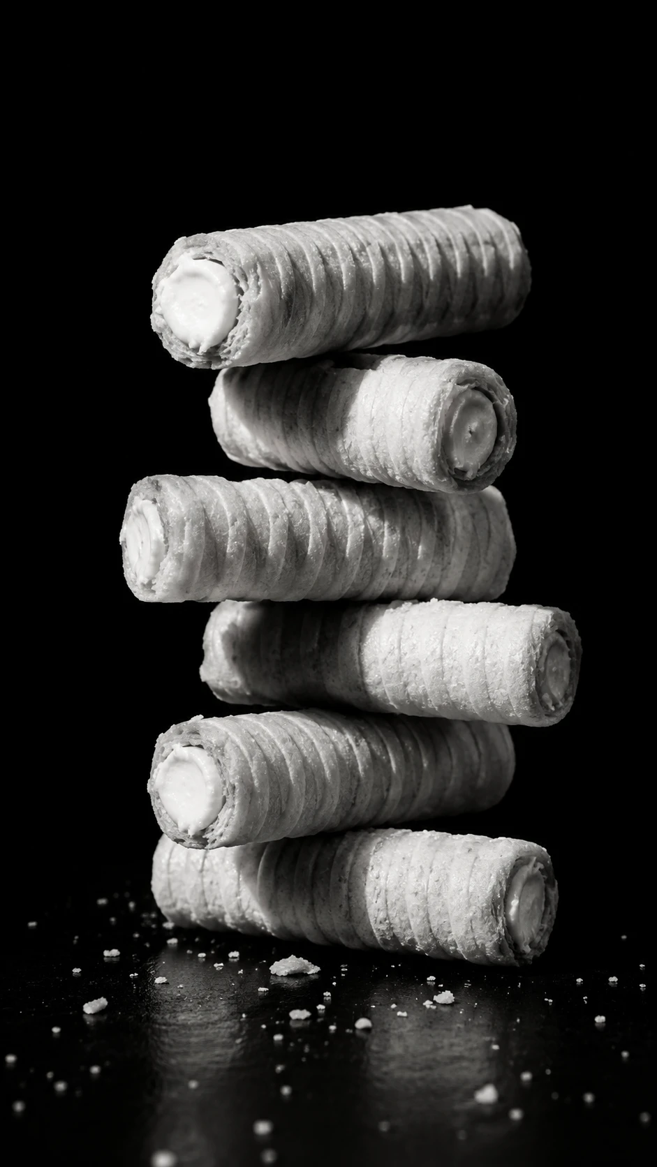 Minimalist wafer cookies stacked against black background