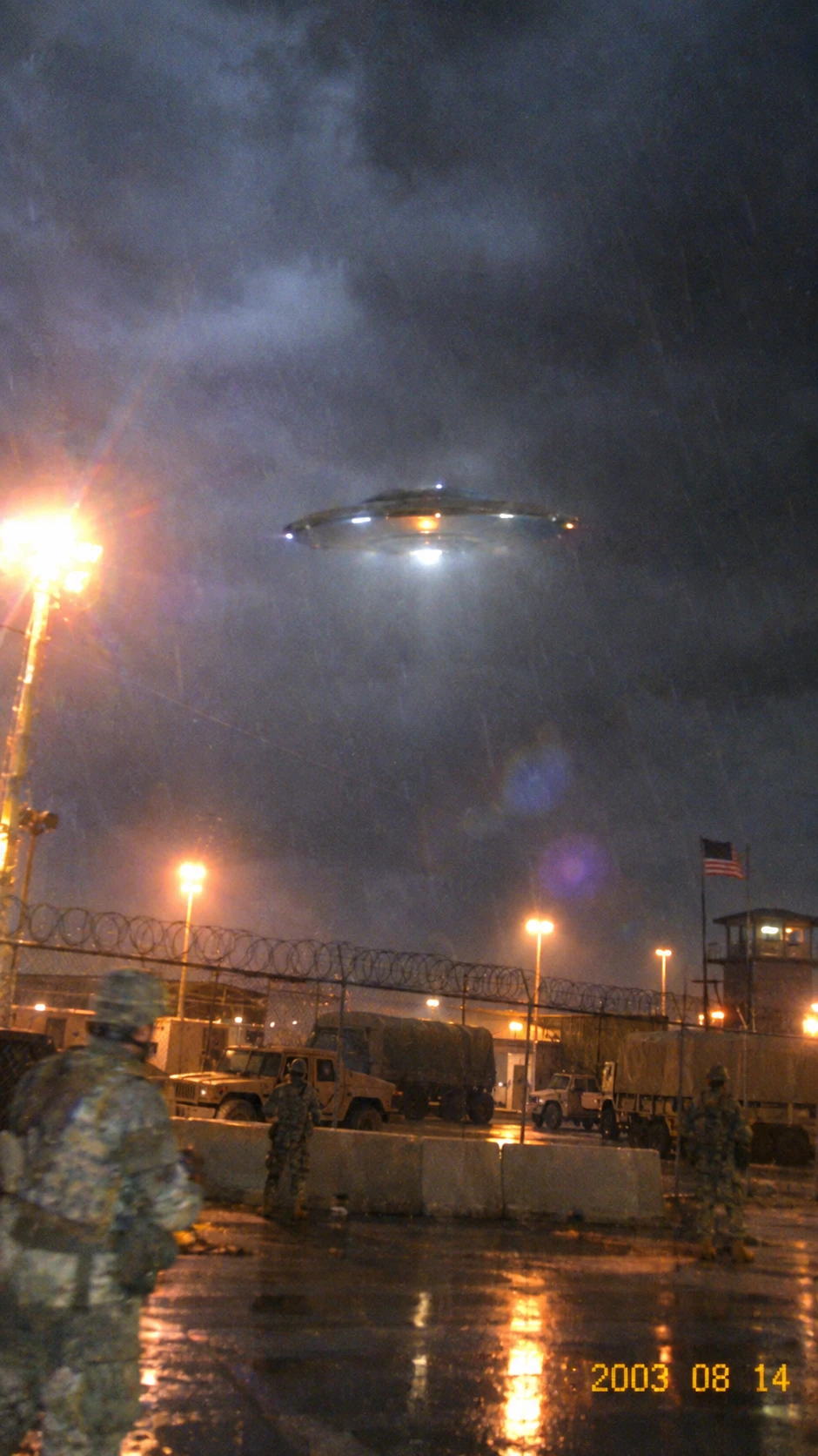 A disc-shaped craft hovers above a military base during a severe storm