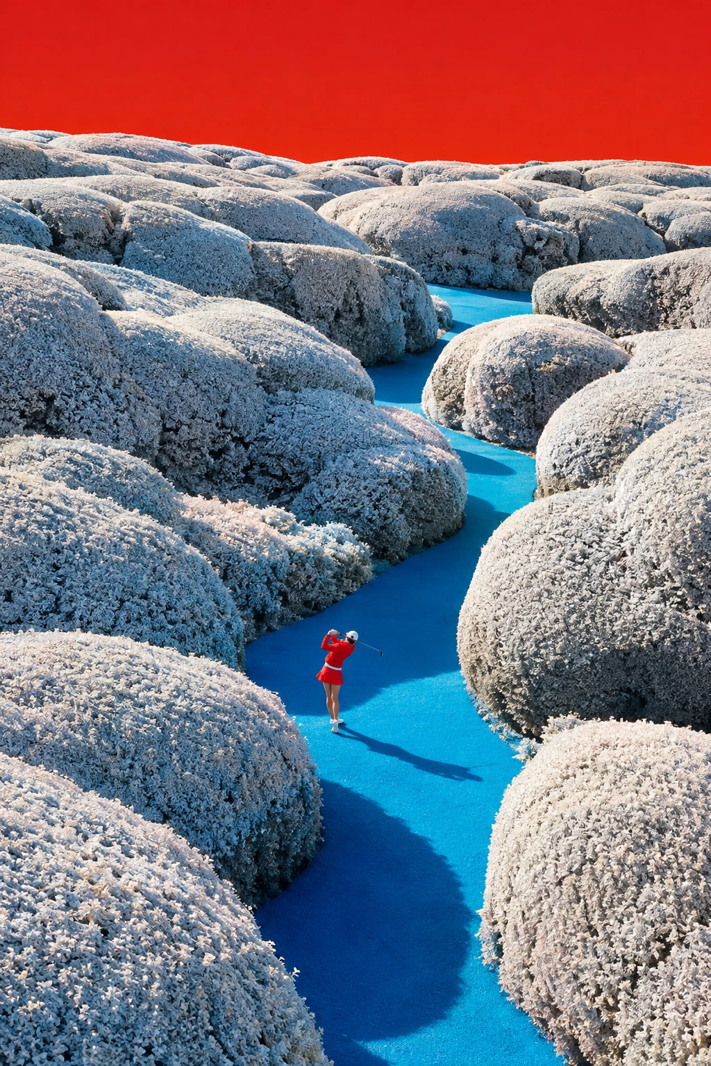 A Golfer Swings Along a Cyan Path Through Snowy Hedge Mounds